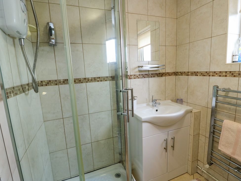 A bathroom with a shower and sink at The Cottage at Ty Newydd in Brynsiencyn