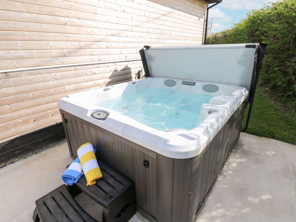 A hot tub with towels on the side at Heritage Retreat in Monknash