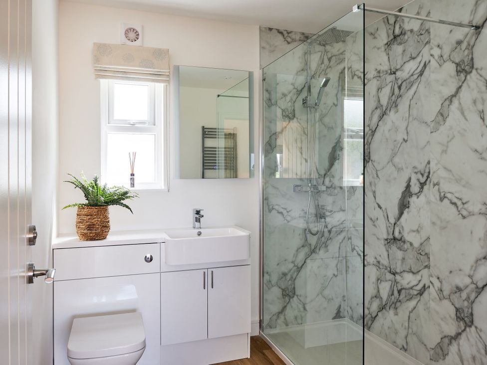 A bathroom with a shower and sink at Monks Rest in Monknash