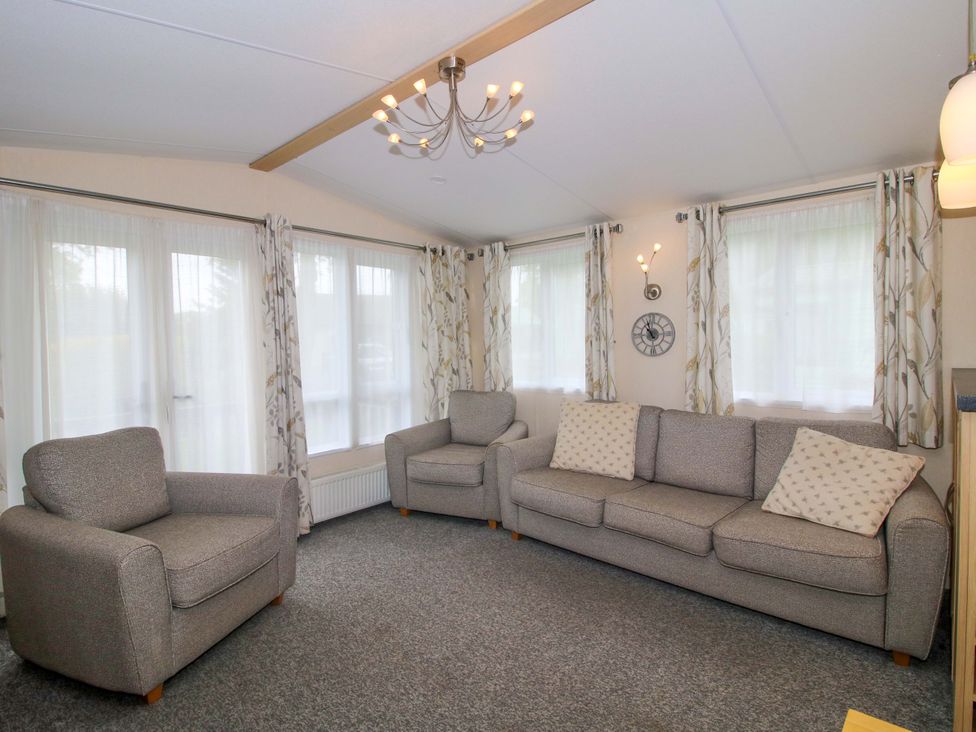 A living room with a sofa and armchair at Dove in Shobdon