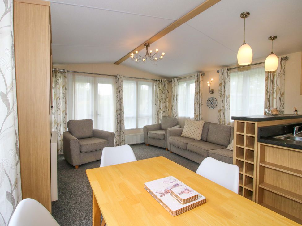 A living room with furniture and a dining area at Dove in Shobdon