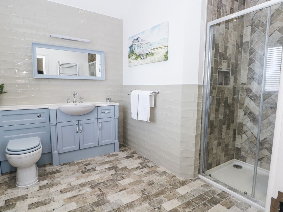 A bathroom with a shower and sink at Meadow Manor And Spa in Prees near Whitchurch