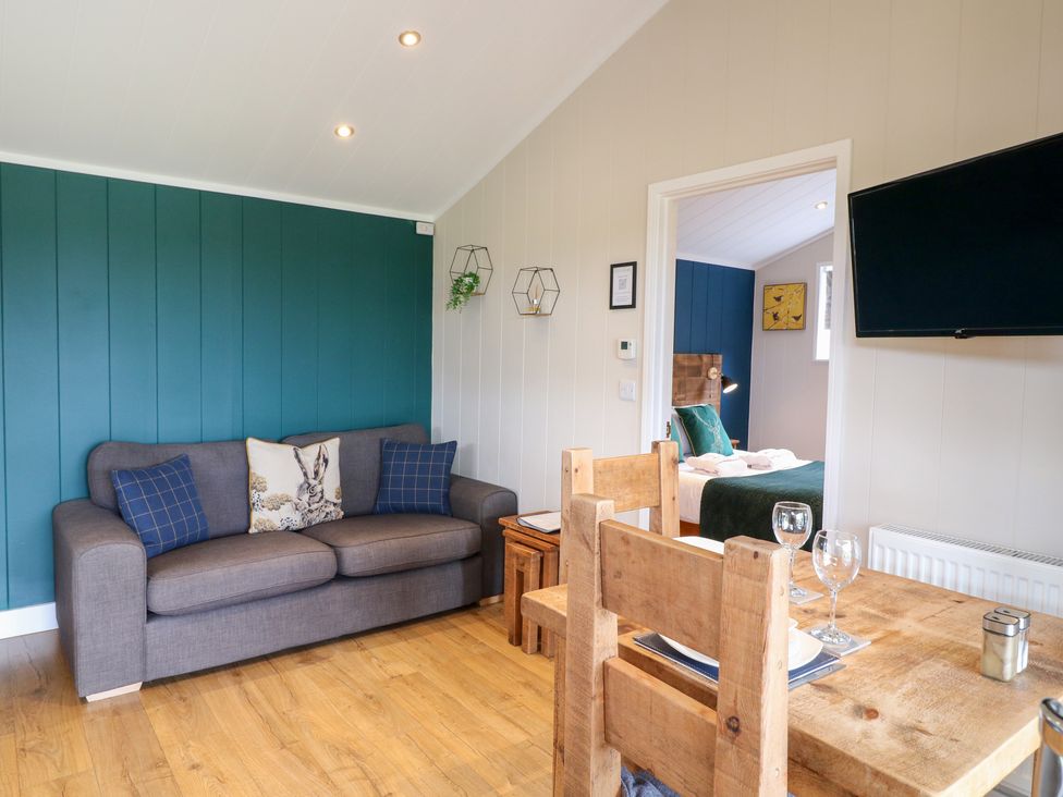 A living room with a sofa and dining table at Hazel Oakthorpe near Donisthorpe