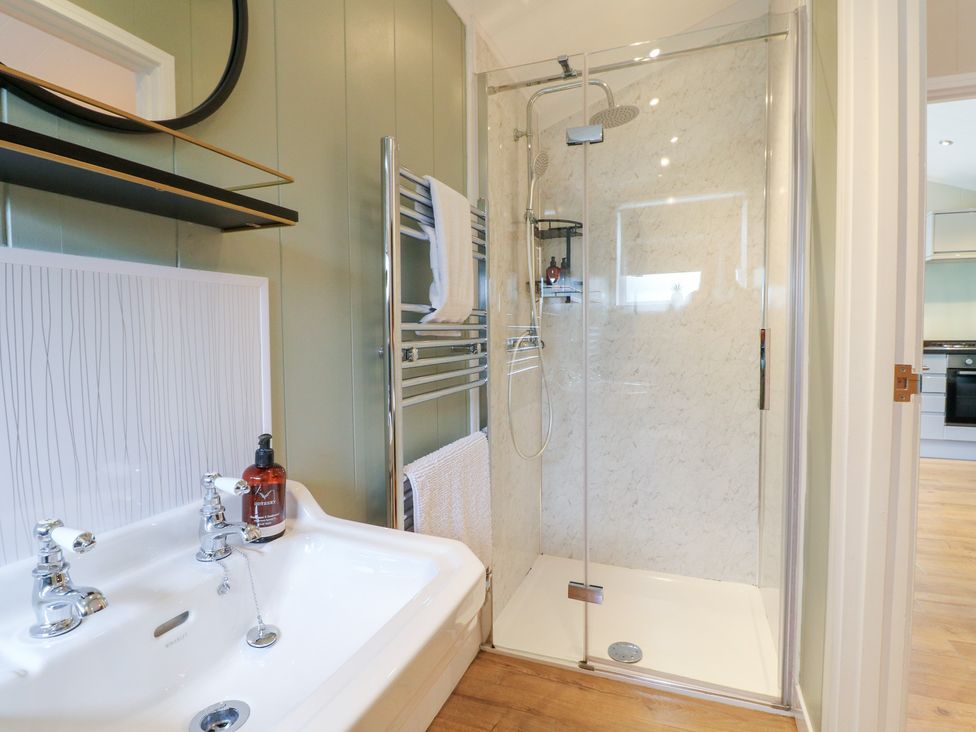 A bathroom with a shower and bathtub at Hazel in Oakthorpe near Donisthorpe