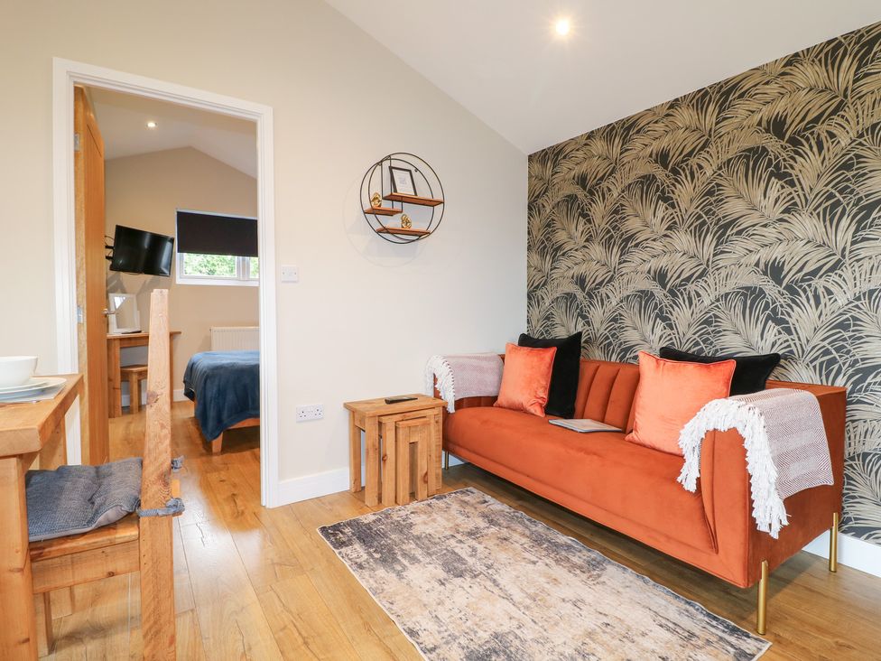 A living room with a sofa and side table at Birch in Oakthorpe near Donisthorpe