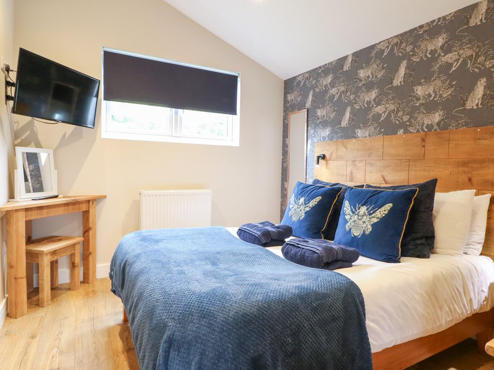 A bedroom with a bed and television at Birch in Oakthorpe near Donisthorpe