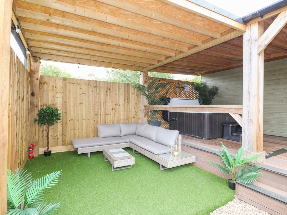 An outdoor seating area with a sofa and a hot tub at Birch in Oakthorpe near Donisthorpe