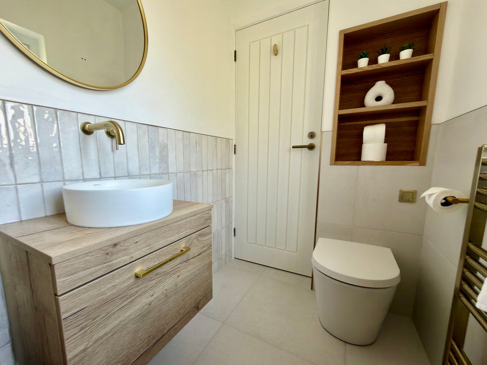 A bathroom with a sink and toilet at Topsails in Totland Bay