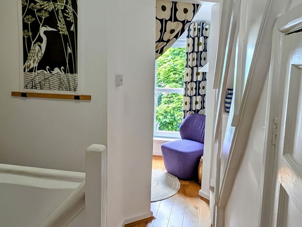 A hallway with wall art and a purple chair at Harbour Retreat in Weymouth