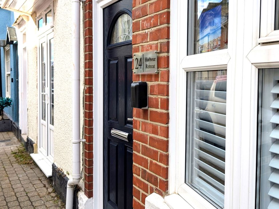 A front entrance with door and window at Harbour Retreat in Weymouth