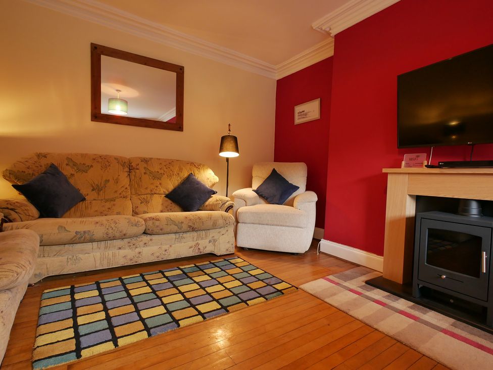 A living room with a sofa and television at Seal Cottage in Eyemouth