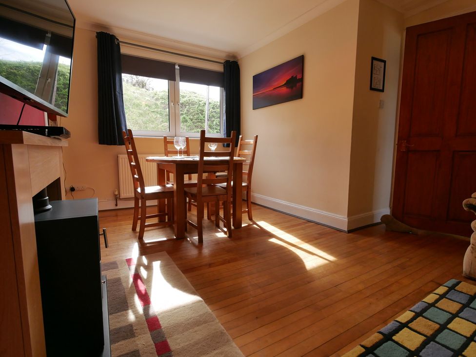 A dining room with a table and chairs at Seal Cottage Eyemouth