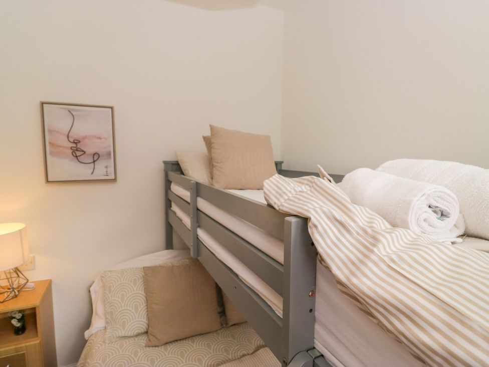 A bunk bed with blankets and pillows at Ruskin Lodge, Langdale 16, White Cross Bay near Windermere