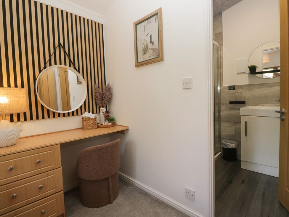 An office space with a desk and a mirror at Ruskin Lodge, Langdale 16, White Cross Bay near Windermere