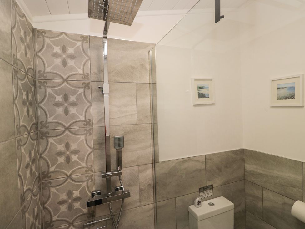 A bathroom with a shower and toilet at Ruskin Lodge, Langdale 16, White Cross Bay near Windermere