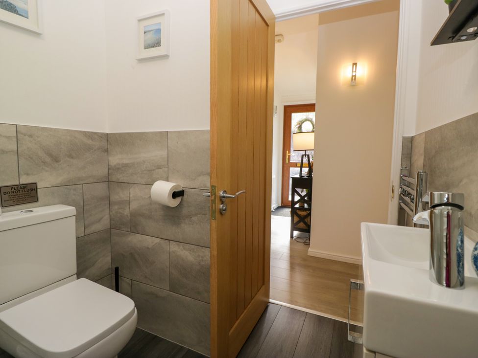 A bathroom with a toilet and sink at Ruskin Lodge, Langdale 16, White Cross Bay near Windermere