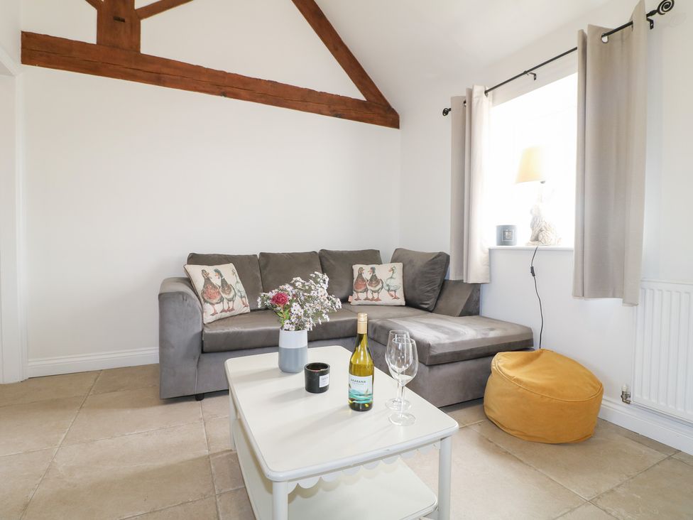 A living room with a sofa and coffee table at The Hereford Lodge in Great Haywood
