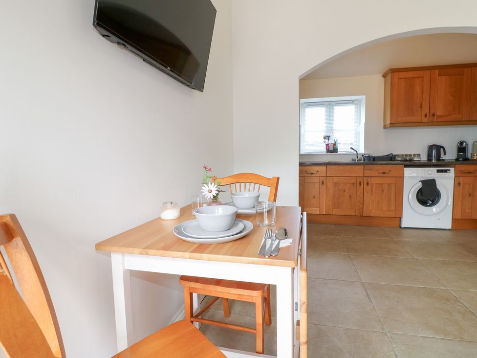 A kitchen with a table set for dining and appliances at The Hereford Lodge Great Haywood