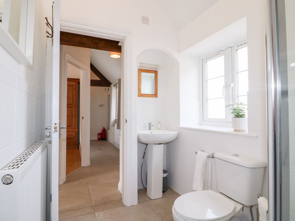 A bathroom with a sink and toilet at The Hereford Lodge in Great Haywood