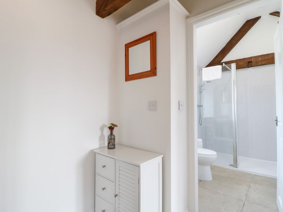 A bathroom with a cabinet and a shower at The Hereford Lodge in Great Haywood