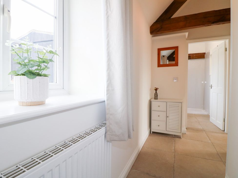 A hallway with a plant on a windowsill at The Hereford Lodge in Great Haywood