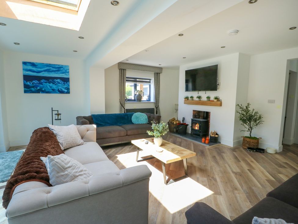 A living room with a sofa and coffee table at Iscoed in Rhosneigr