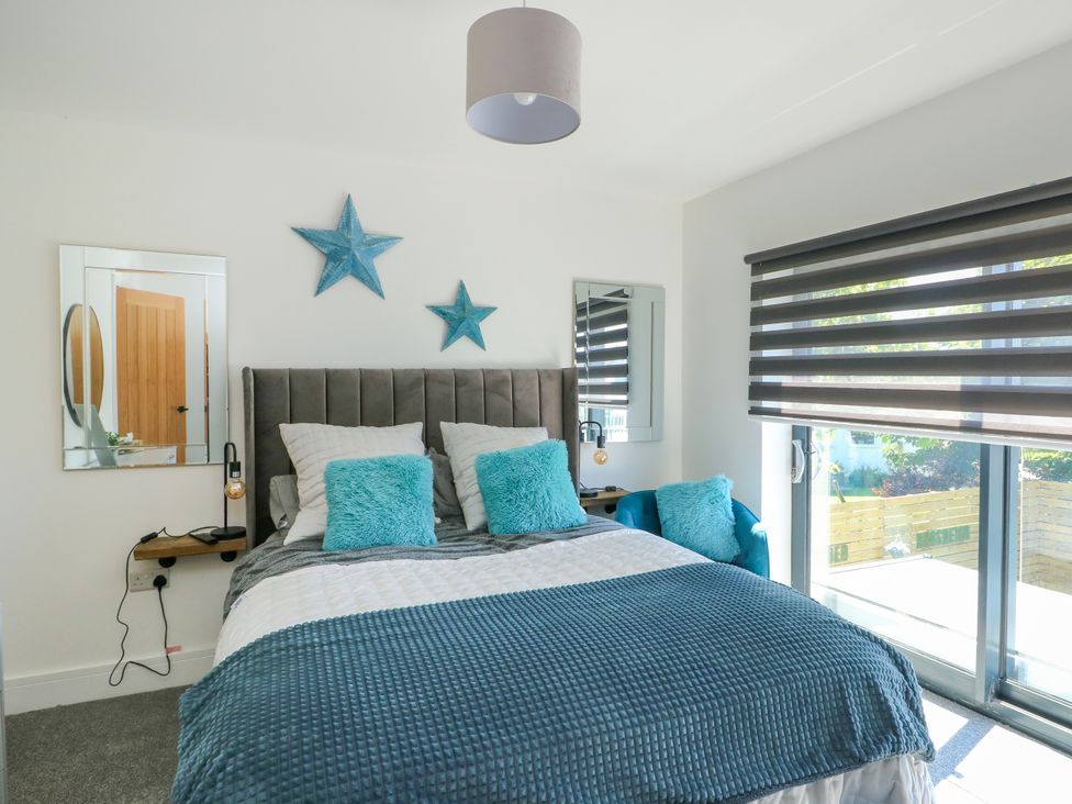 A bedroom with a bed and star decorations at Iscoed in Rhosneigr