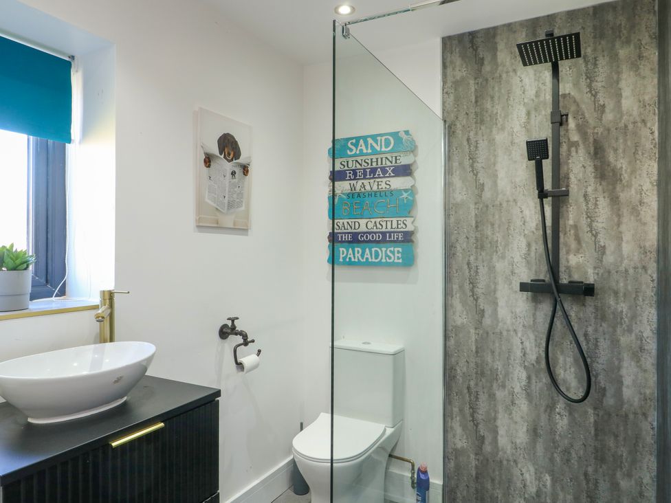A bathroom with a sink and shower at Iscoed in Rhosneigr