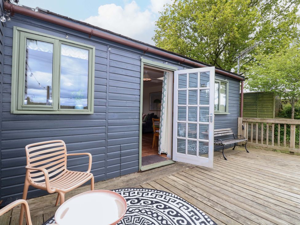 An outdoor area with a chair and table at Foxglove in King's Lynn