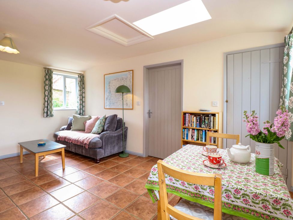 A living room with a sofa and table at Foxglove in King's Lynn