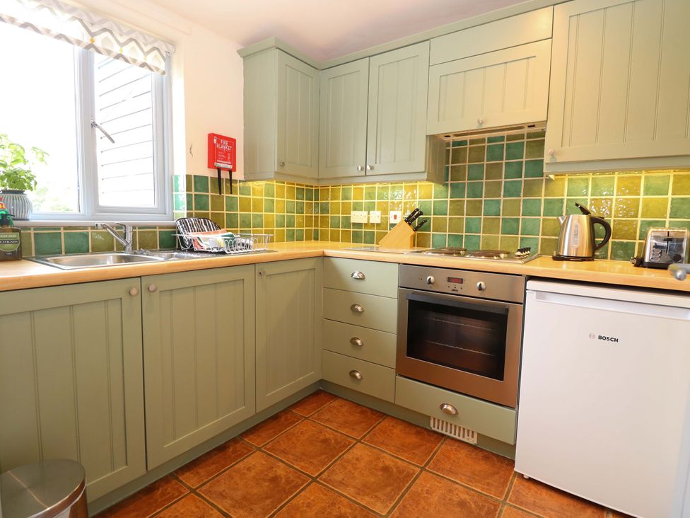A kitchen with cabinets and appliances at Foxglove in King's Lynn
