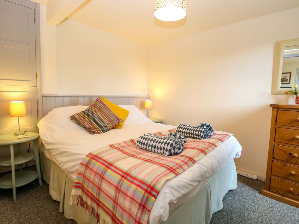 A bedroom with a bed and bedside tables at Foxglove in King's Lynn
