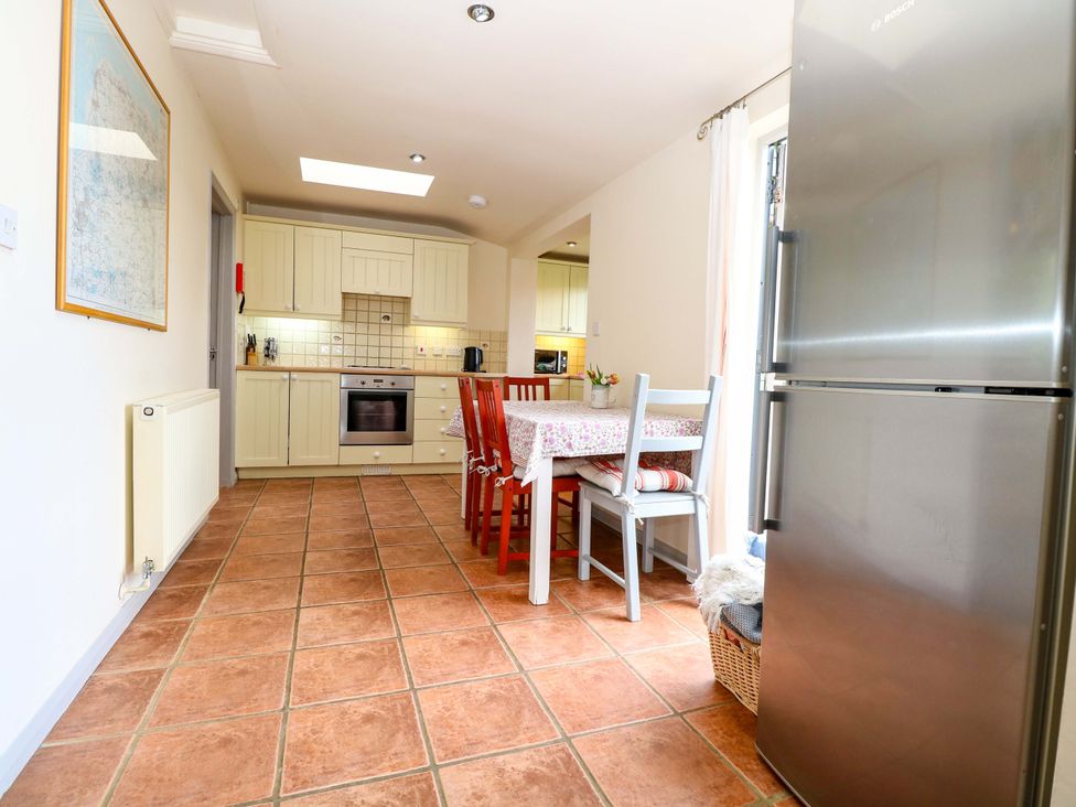 A kitchen with a table and chairs at Hollyhock in King's Lynn