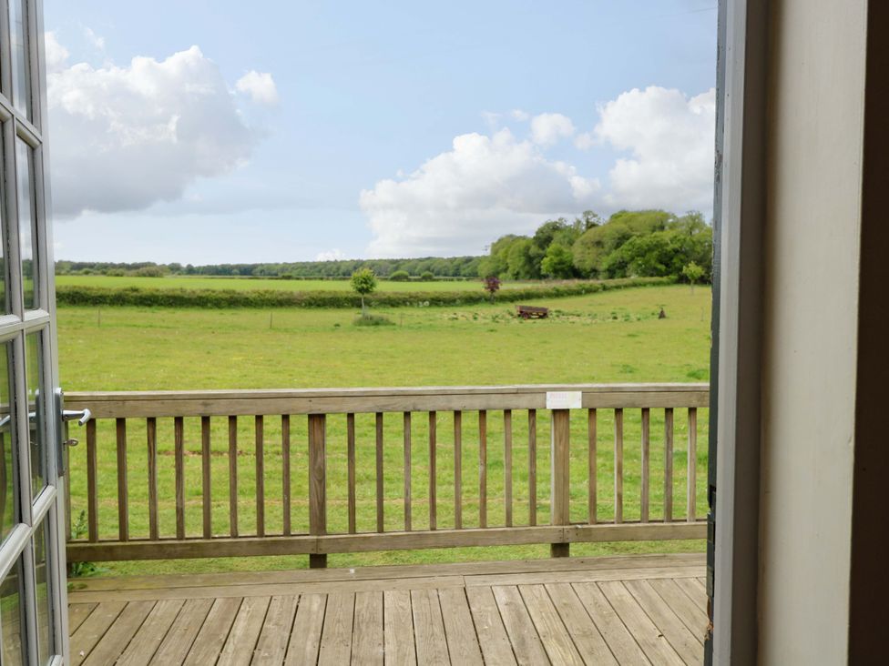 A view from a deck overlooking a field at Hollyhock in King's Lynn