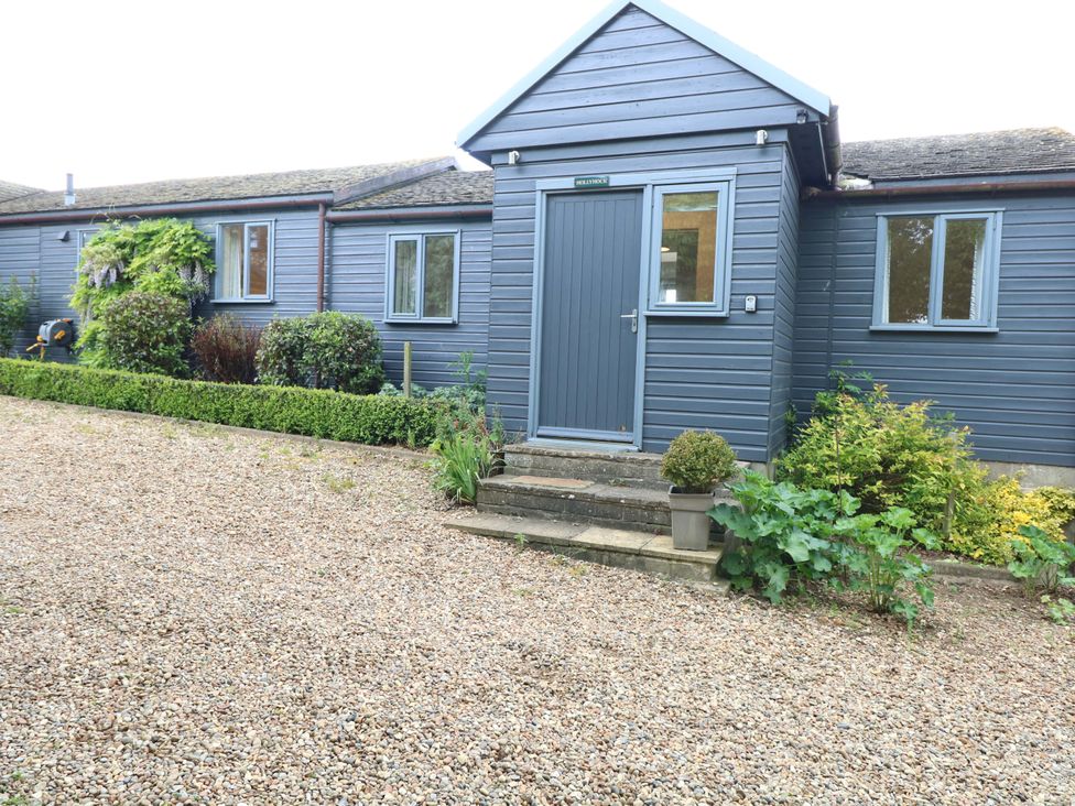 A house exterior with a front door and gravel path at Hollyhock in King's Lynn