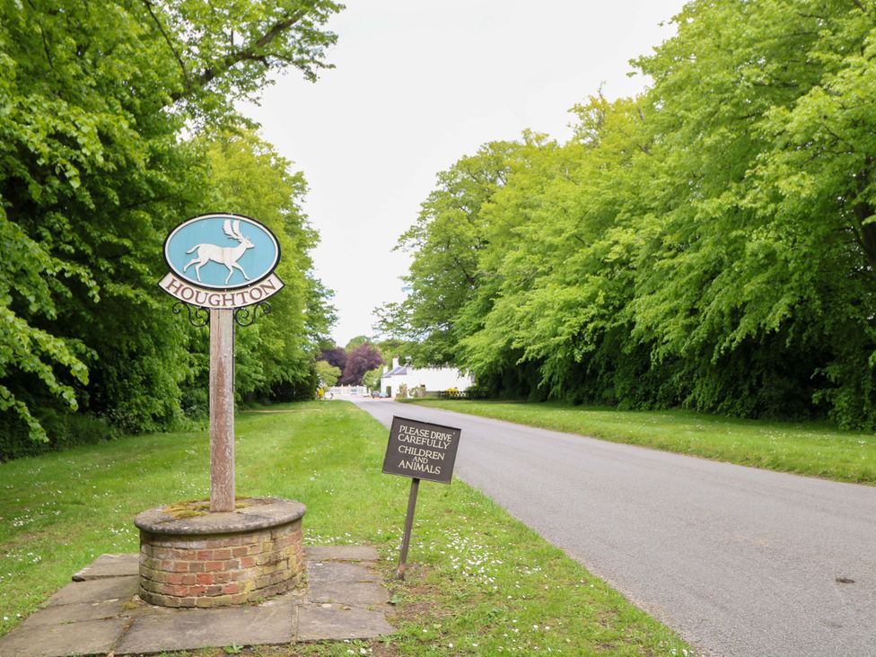 A road with a village sign in Houghton near King's Lynn