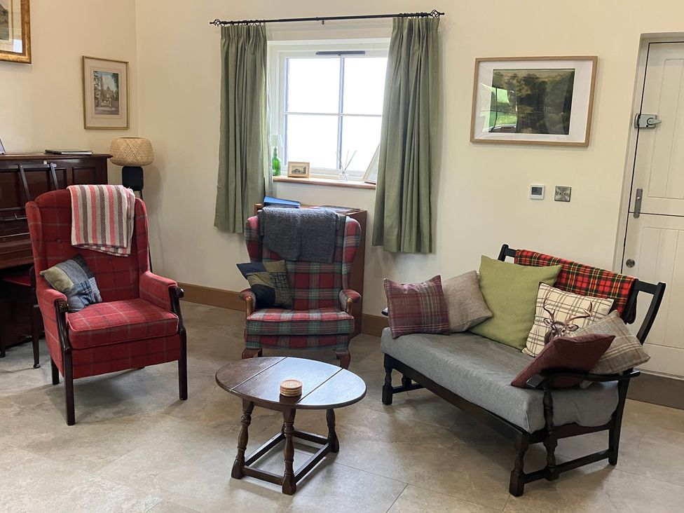 A living room with two armchairs and a sofa at The Croft in Newtown-Crommelin near Cloughmills