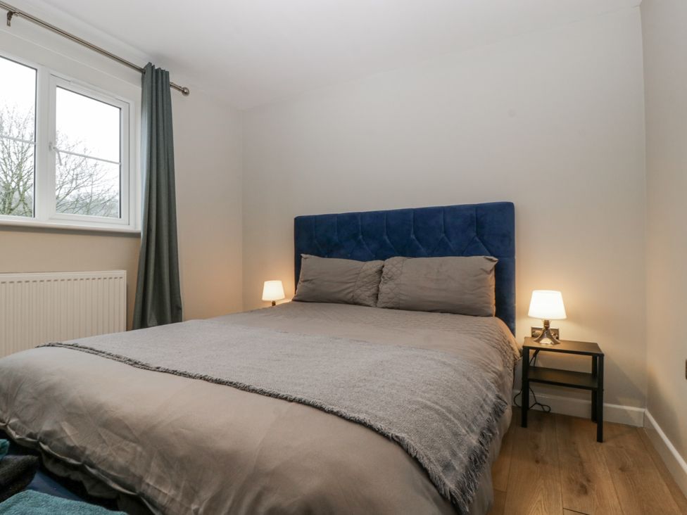 A bedroom with a bed and a bedside table at Ranbir House Longhope