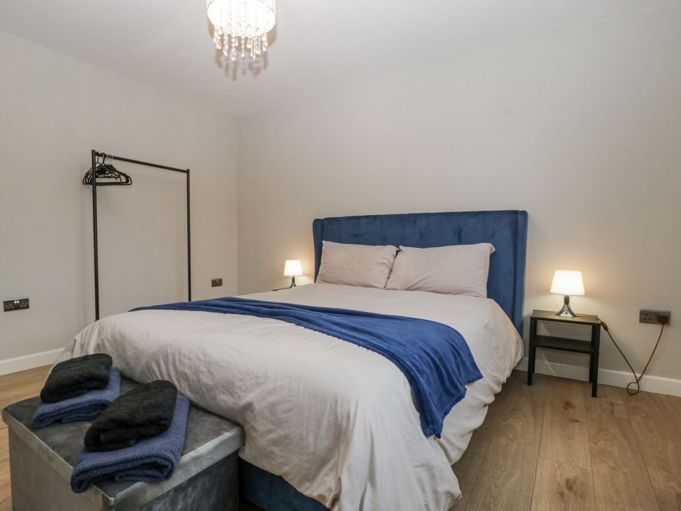 A bedroom with a bed and bedside table at Ranbir House in Longhope