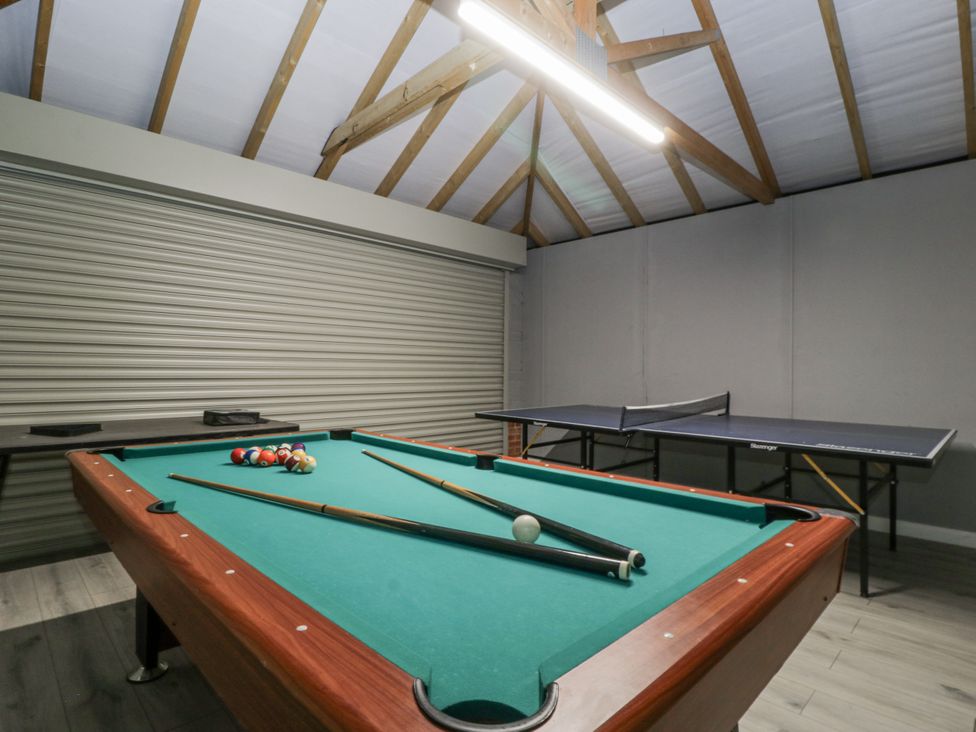 A game room with a pool table and ping pong table at Ranbir House in Longhope
