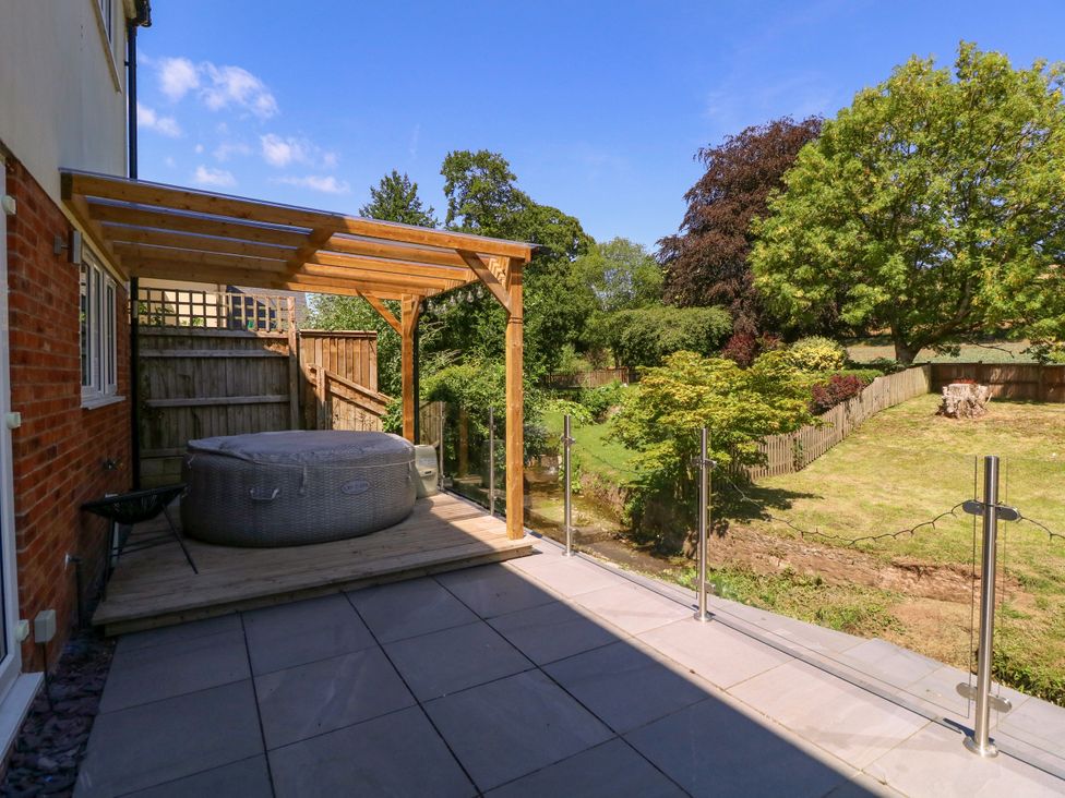 An outdoor space with a hot tub and decking at Ranbir House in Longhope
