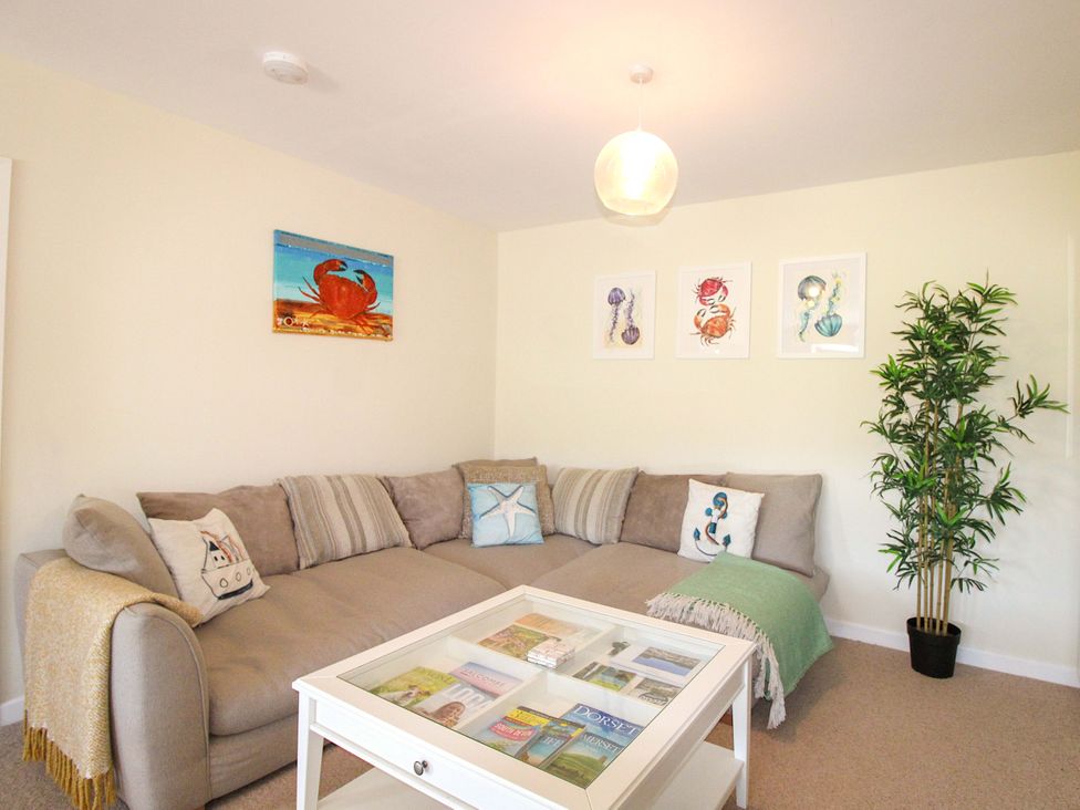 A living room with a sofa and coffee table at Tansea in Hope Cove