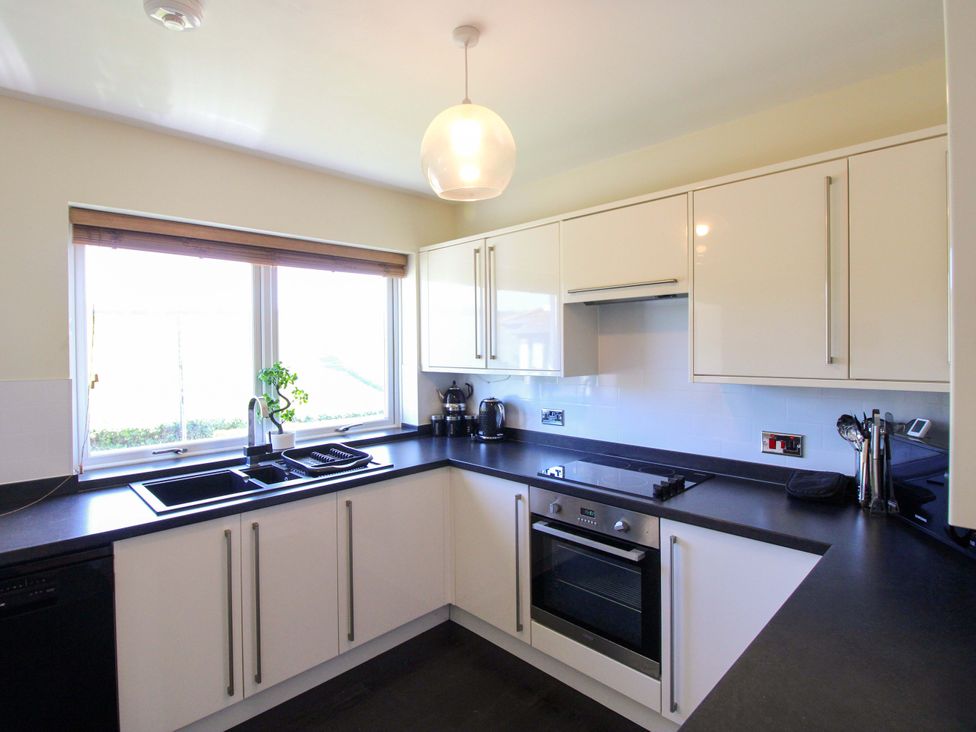 A kitchen with a sink and cooking appliances at Tansea in Hope Cove