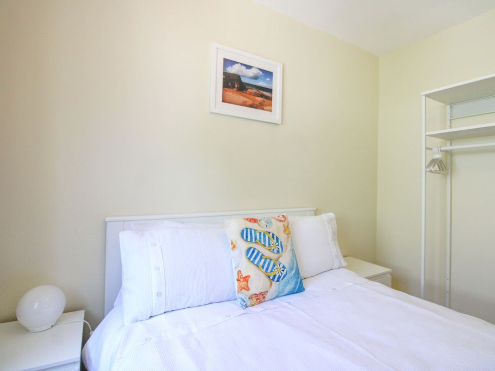 A bedroom with a bed and a closet at Tansea in Hope Cove