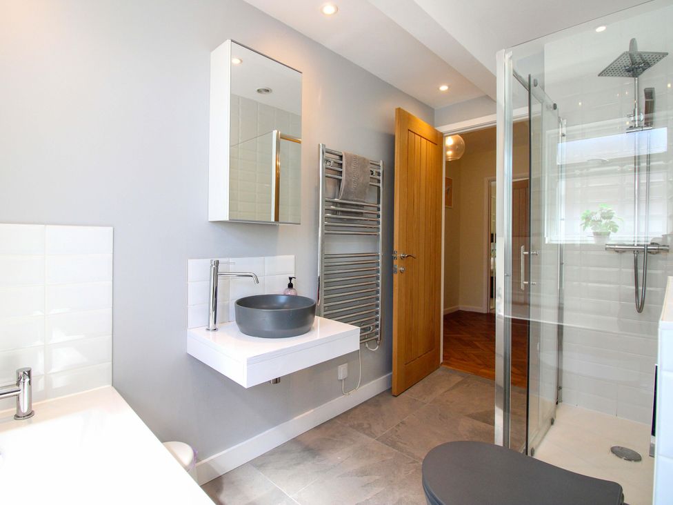 A bathroom with a sink and shower at Tansea in Hope Cove