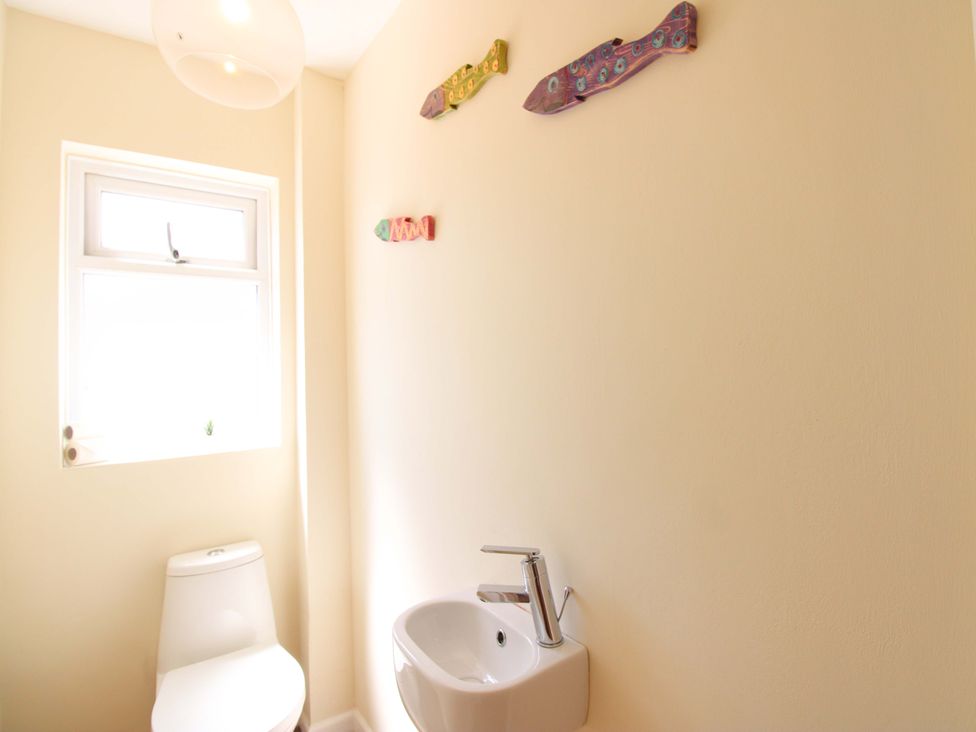 A bathroom with a toilet and sink at Tansea in Hope Cove