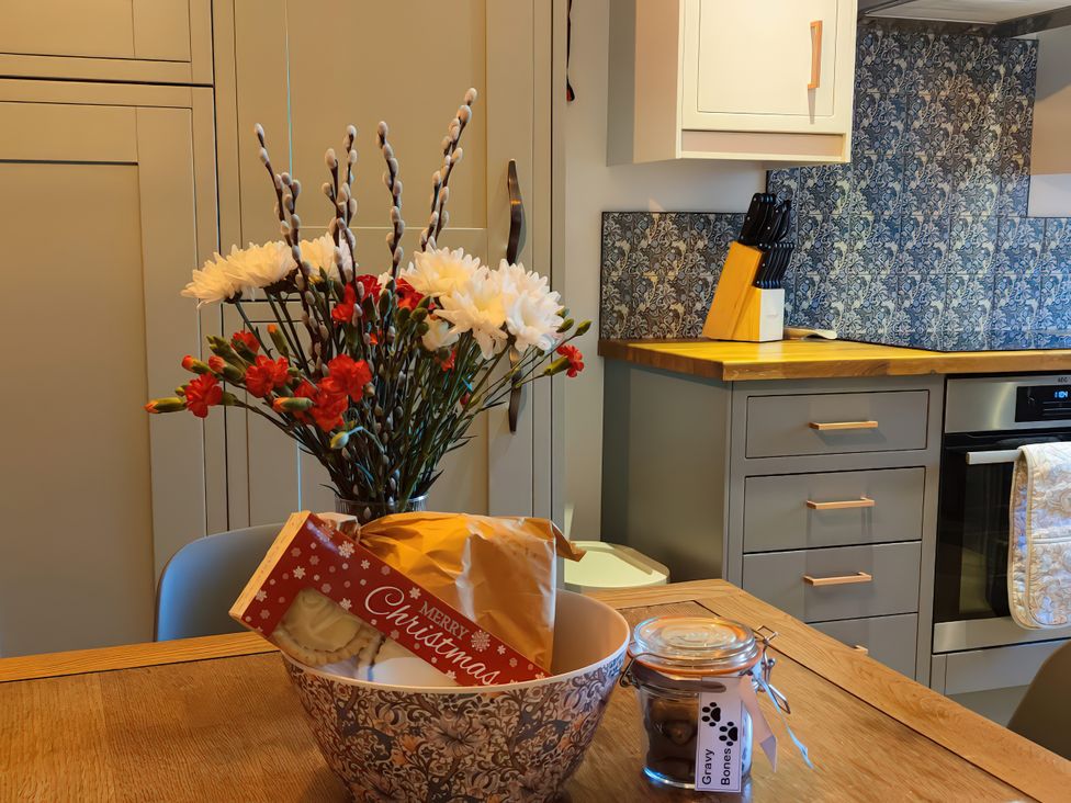A bowl with snacks and flowers on a table at Courthouse Cottage, Eckington, Derbyshire