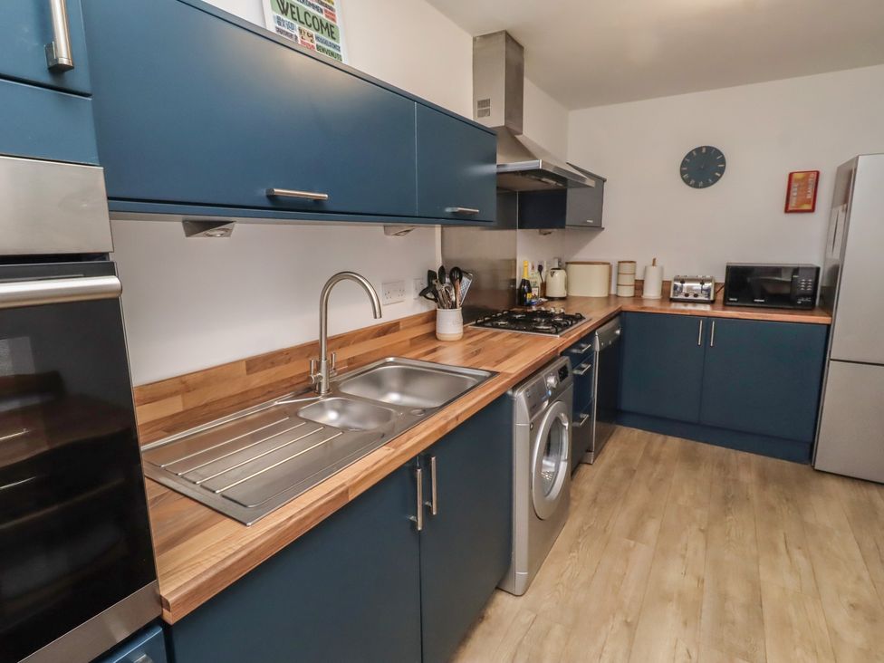 A kitchen with appliances and countertop at Brucap Cottage Beadnell
