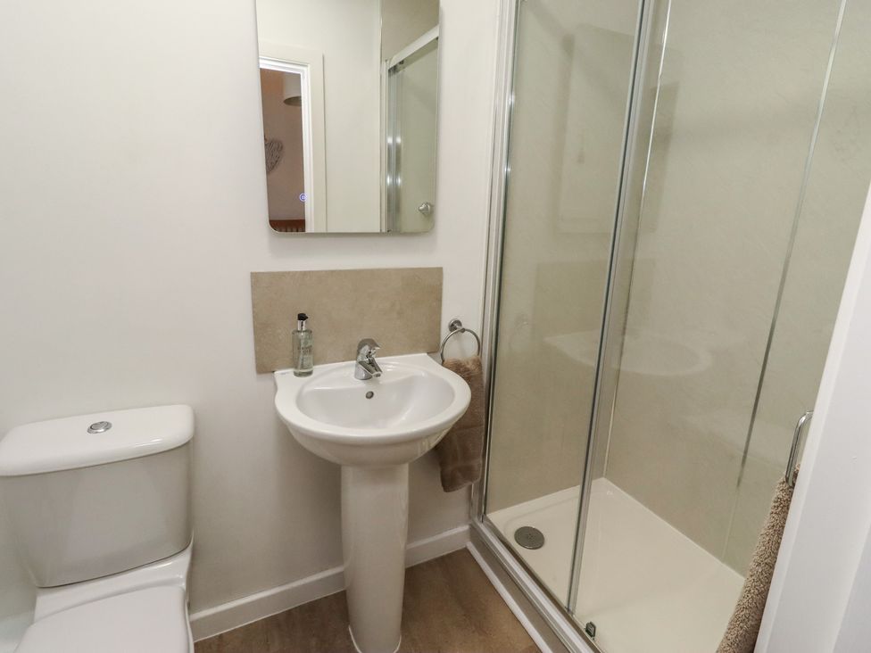 A bathroom with a sink and shower at Brucap Cottage Beadnell