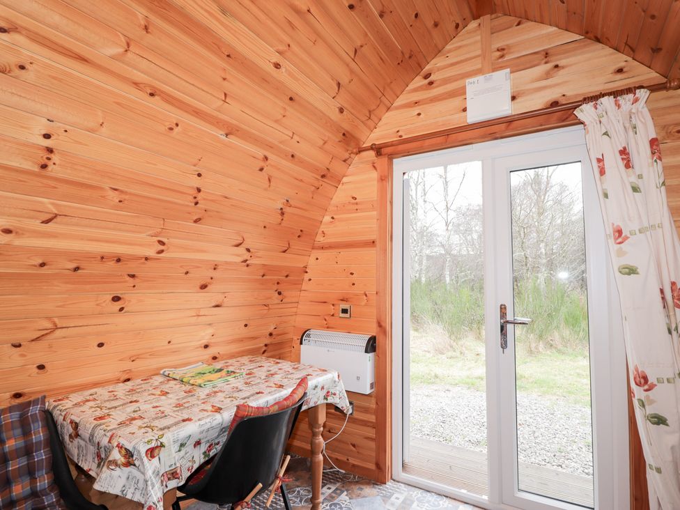 A small dining area with a table and chairs at Pod 1 